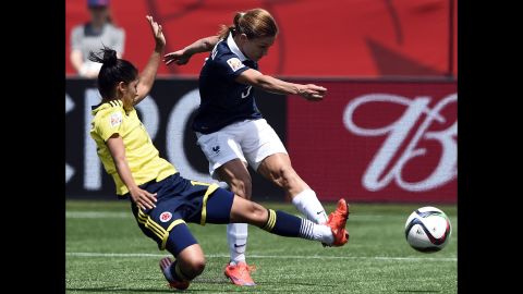 French defender Laure Boulleau, right, shoots next to Colombian midfielder Carolina Arias during a match in Moncton on June 13. Colombia won 2-0.