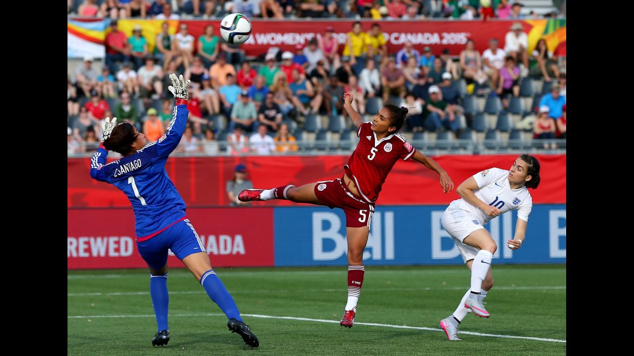 England's Karen Carney, right, gets a shot past Valeria Miranda and Cecilia Santiago of Mexico on Saturday, June 13. England won 2-1 in Moncton.