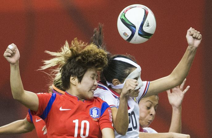 Costa Rica's Wendy Acosta, right, challenges South Korea's Ji Soyun during their 2-2 tie June 13 in Montreal.