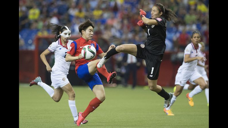 Costa Rica goalkeeper Dinnia Diaz comes out to knock the ball away from South Korea's Lee Geummin.
