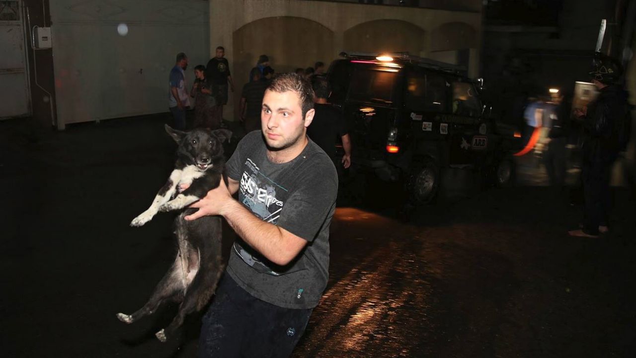 A man helps rescue a dog during flooding in Tbilisi, Georgia.