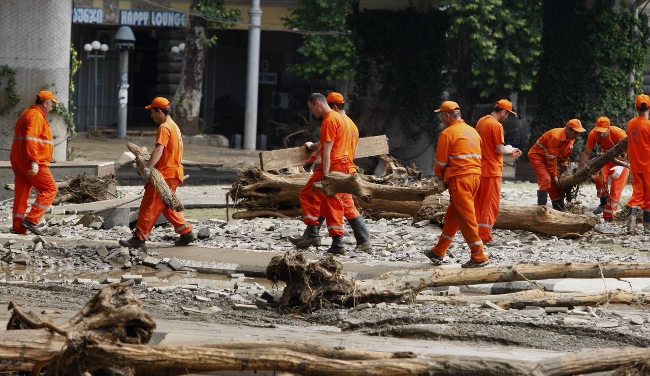 Municipal workers clean an area around the zoo on June 14.