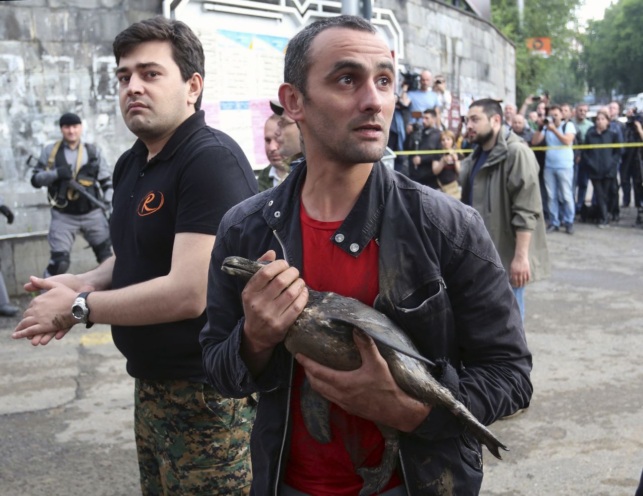 A man carries a bird that he rescued on June 14.