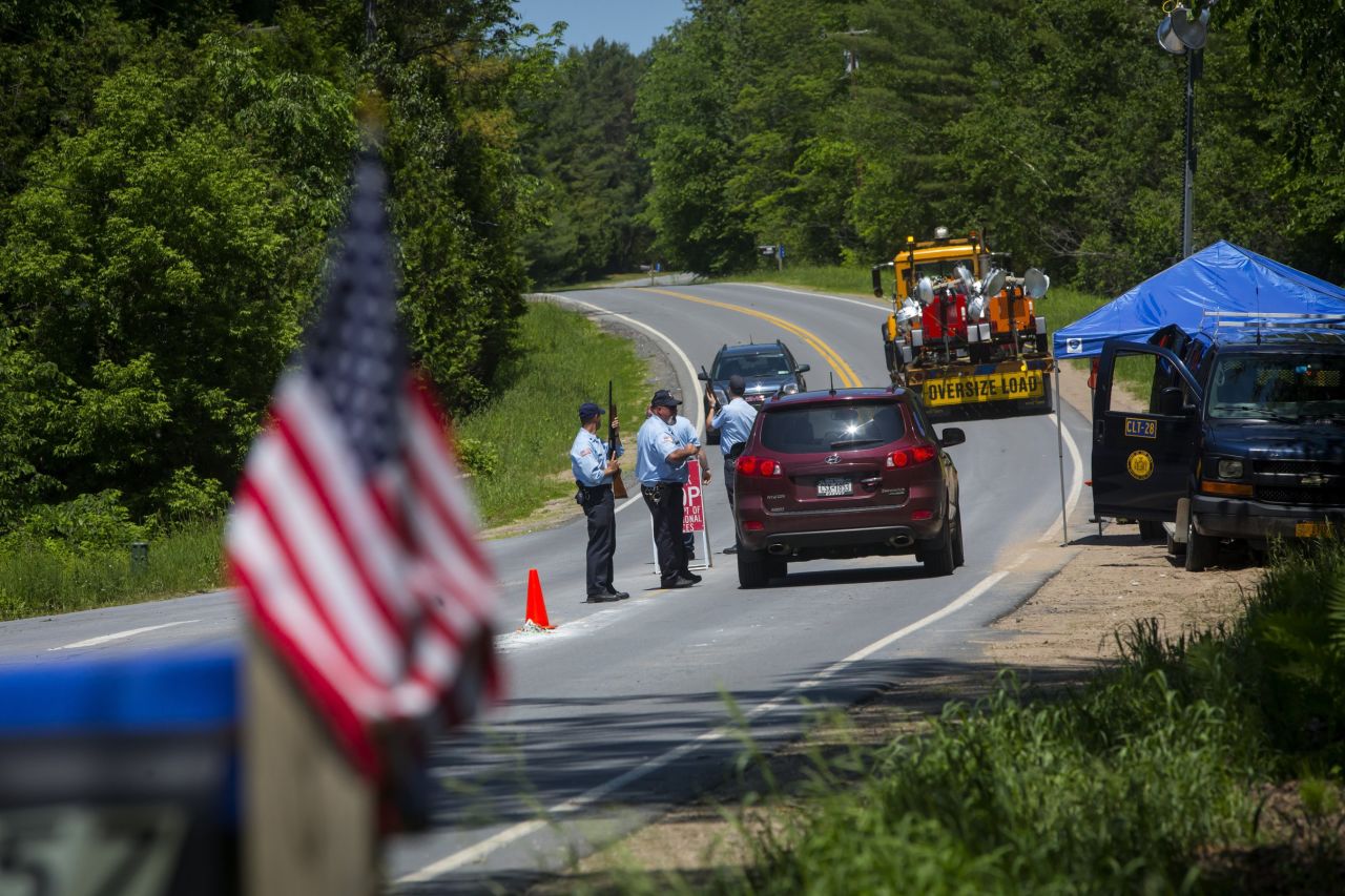 Department of Corrections officers work a roadblock in Saranac, New York, on Saturday, June 13. 