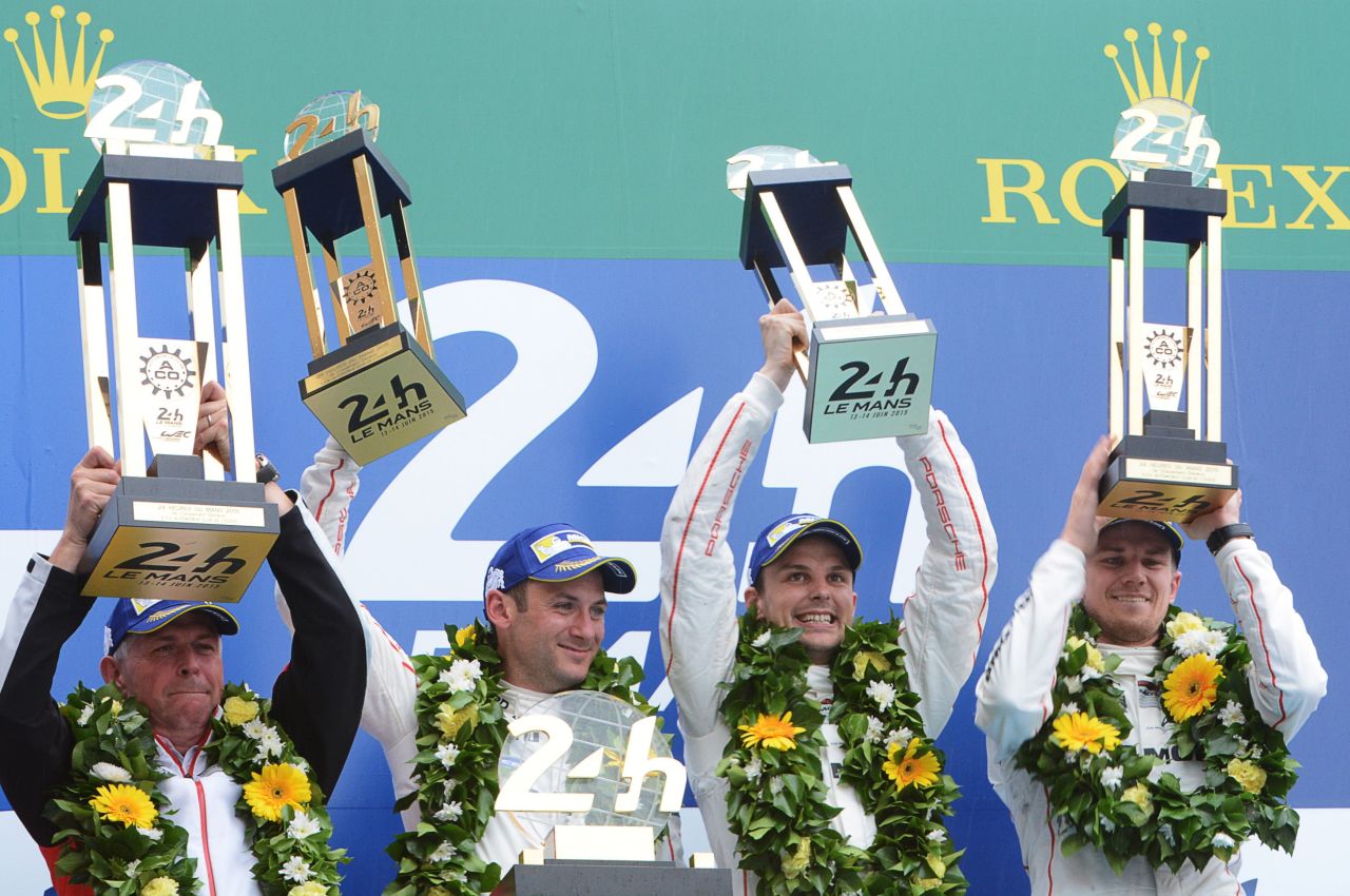 Porsche's development director Wolfgang Hatz celebrates with winning drivers Nick Tandy, Earl Bamber and Nico Hulkenberg, after the 83rd Le Mans 24 Hours endurance race.
