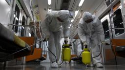 Disinfection workers wearing protective gears spray anti-septic solution in an subway amid rising public concerns over the spread of MERS virus at Seoul metro railway base on June 9, 2015 in Goyang, South Korea.