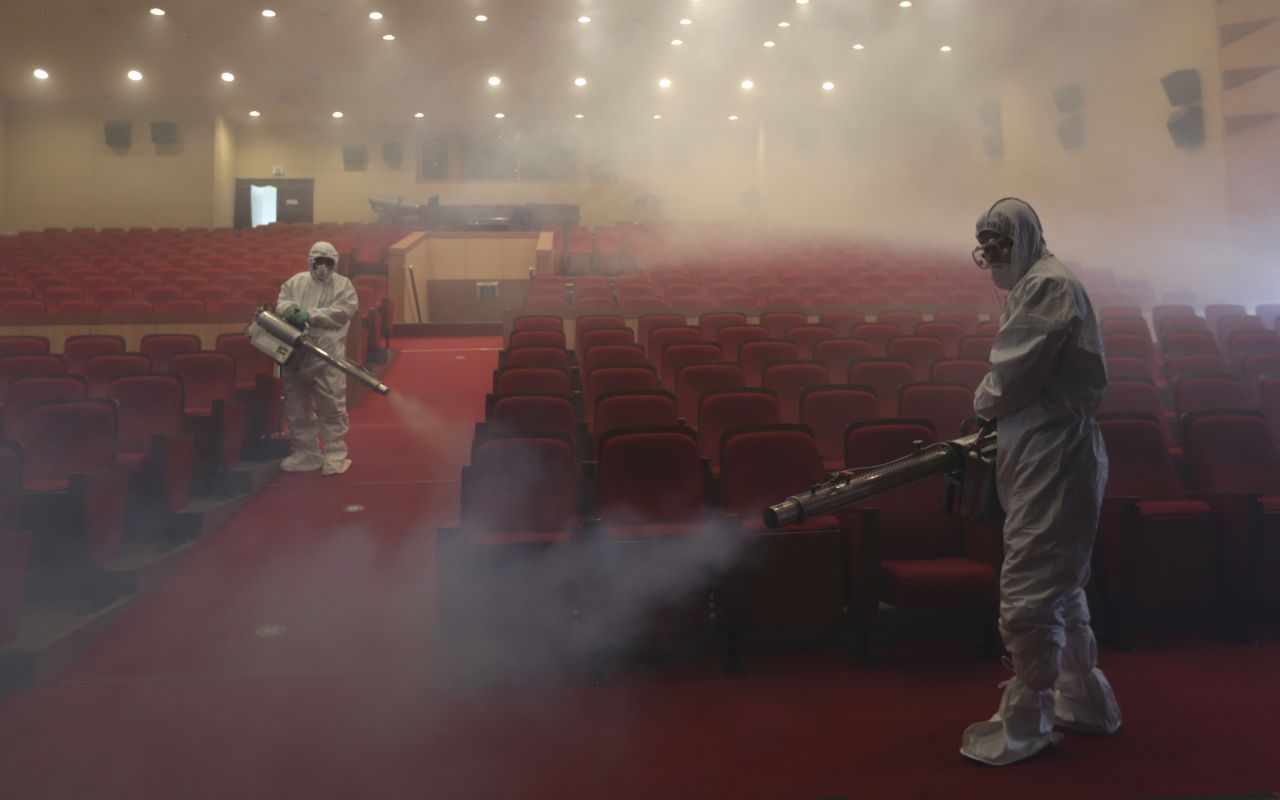 Workers wearing protective gears spray antiseptic solution as a precaution against the spread of MERS at an art hall in Seoul, South Korea, on Friday, June 12, 2015. 