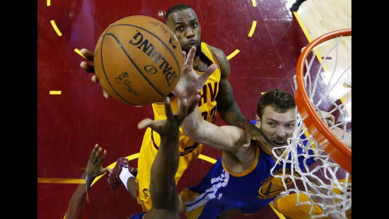 LeBron James, left, and David Lee reach for the ball during Game 4 of the NBA Finals on Thursday, June 11. Lee and the Golden State Warriors defeated James' Cleveland Cavaliers 103-82 to even the best-of-seven series at two games apiece.