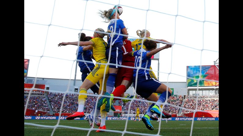 U.S. goalkeeper Hope Solo, in red, leaps for a save during a Women's World Cup match against Sweden on Friday, June 12. The match in Winnipeg, Manitoba, ended in a scoreless draw. 