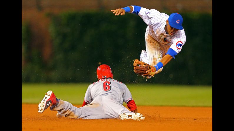 Cincinnati's Billy Hamilton steals second base, avoiding Addison Russell's tag Sunday, June 14, in Chicago. Hamilton had five stolen bases in the game, which Cincinnati won 2-1.
