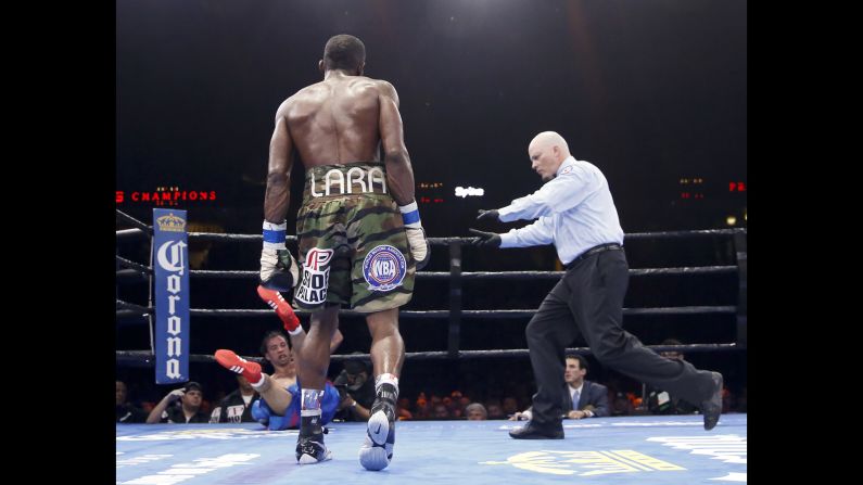 Delevin Rodriguez falls to the canvas after being knocked down by Erislandy Lara in Chicago on Friday, June 12. Lara won by unanimous decision to retain his WBA super-welterweight title.