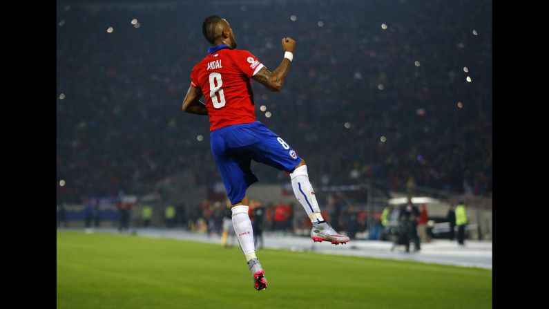 Chile's Arturo Vidal celebrates Thursday, June 11, after he scored a penalty against Ecuador in the opening match of the Copa America tournament. Chile, the tournament's host country, won 2-0 in Santiago.