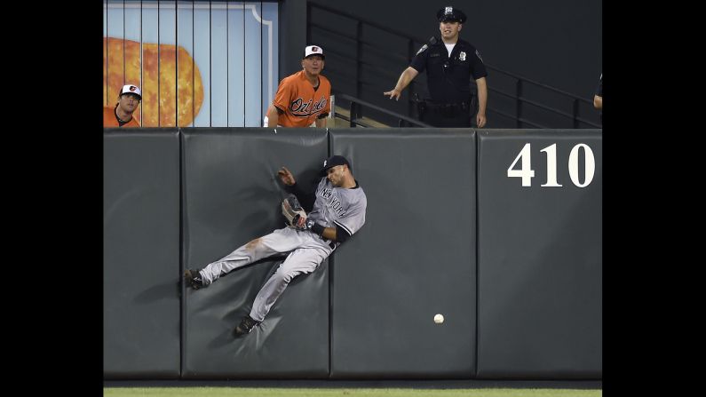 New York Yankees outfielder Mason Williams crashes into the wall as he tries to catch a fly ball in Baltimore on Saturday, June 13.
