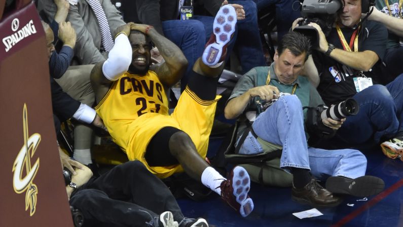 LeBron James clutches his head after falling into a cameraman during Game 4 of the NBA Finals on Thursday, June 11. James suffered a nasty cut but went on to finish the game.