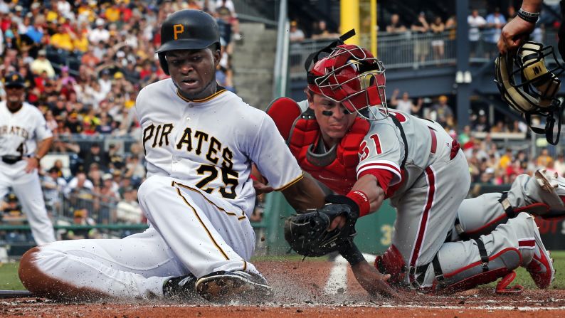 Pittsburgh's Gregory Polanco scores a run after the ball was knocked from the glove of Philadelphia's Carlos Ruiz on Saturday, June 13.