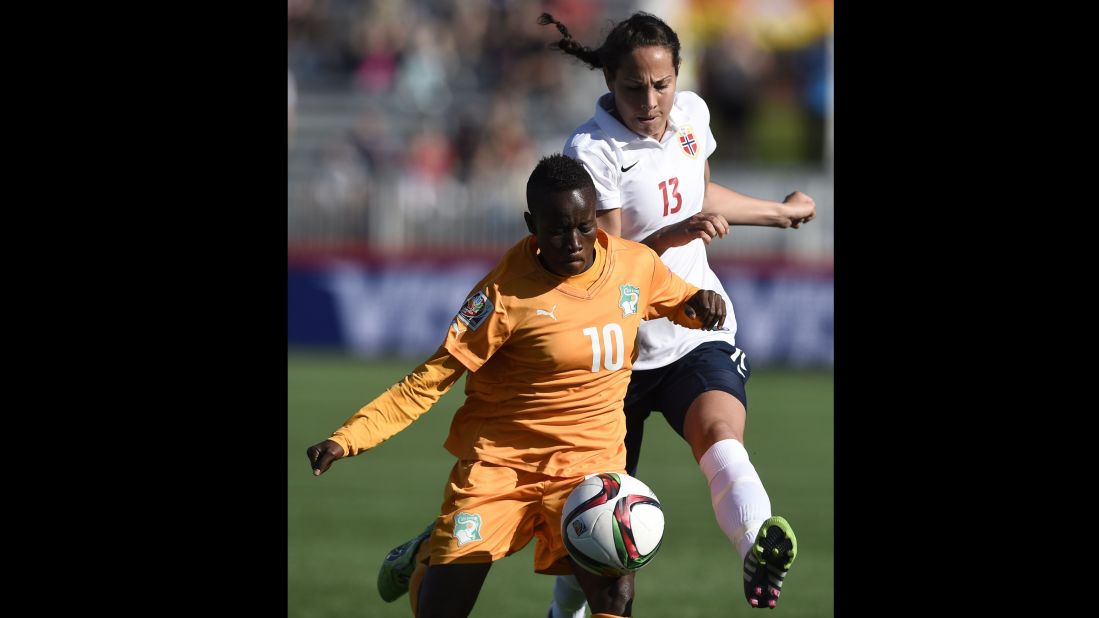 Ivory Coast forward Ange Nguessan, left, holds off Norway defender Ingrid Moe Wold. 