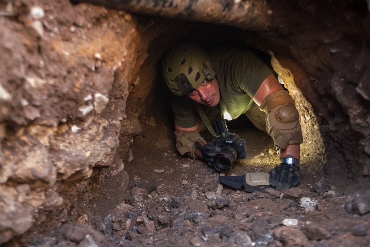 A border patrol agent inspects a tunnel near Nogales, Arizona. Tunnels like this are used to transport drugs under the U.S. border. 