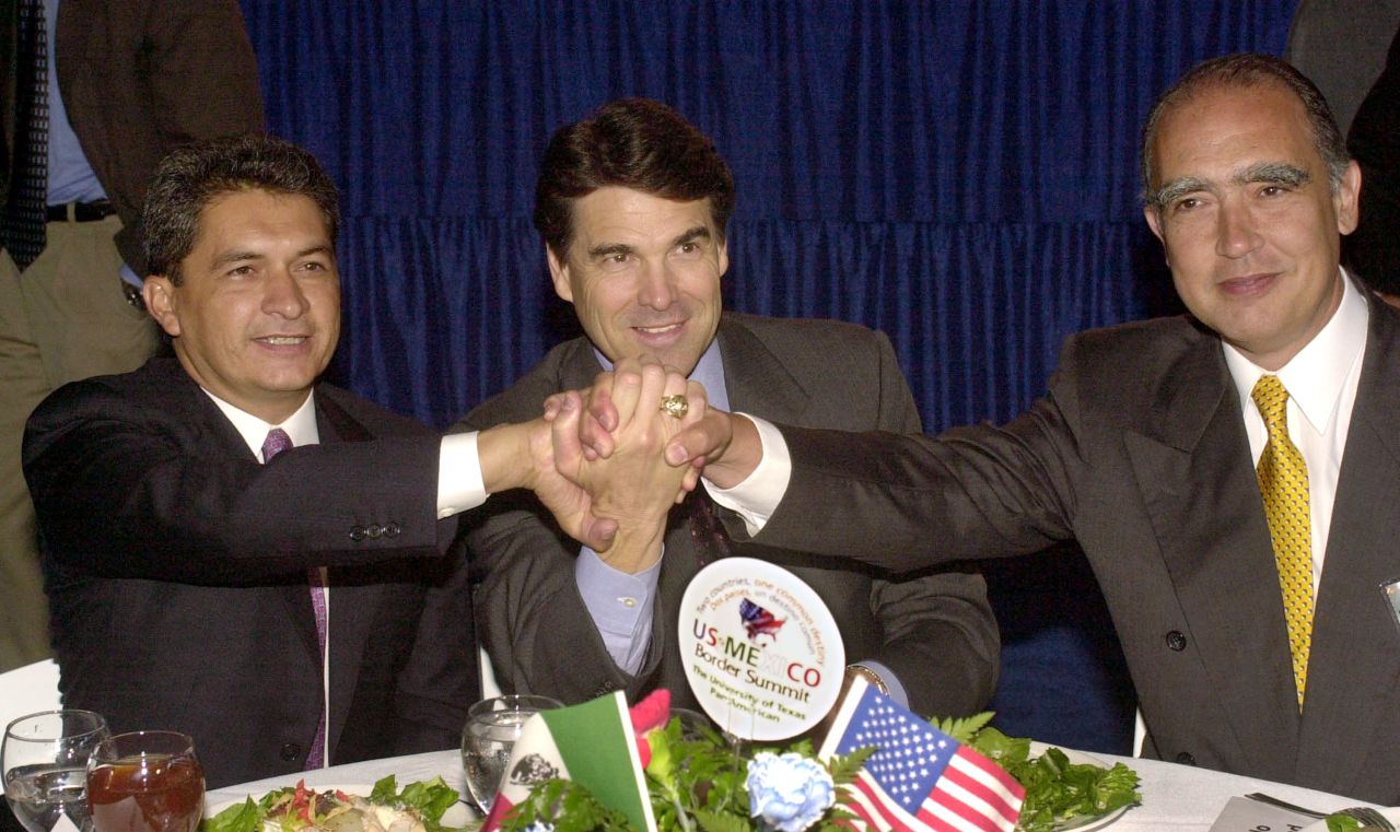 Mexican politician Tomas Yarrington, from left, then-Texas Gov. Rick Perry and Nuevo Leon Gov. Fernando Canales Clariond join hands during the U.S. and Mexico Border Summit on August, 22, 2001, in Edinburg, Texas. Perry, who is currently running for the 2016 GOP presidential nomination, is headed to the Rio Grande Valley in June for a fund-raiser with area elected officials.