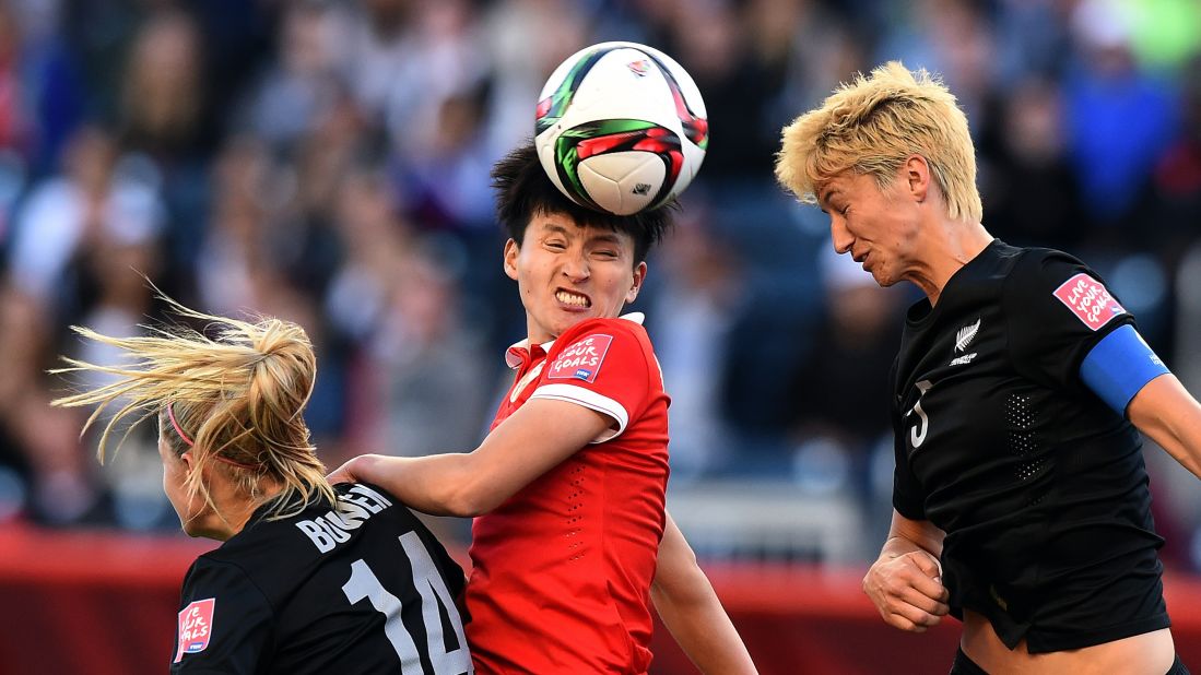 Chinese defender Wang Shanshan, center, heads the ball between two New Zealand defenders during a match in Winnipeg, Manitoba, on Monday, June 15. The match ended 2-2. 