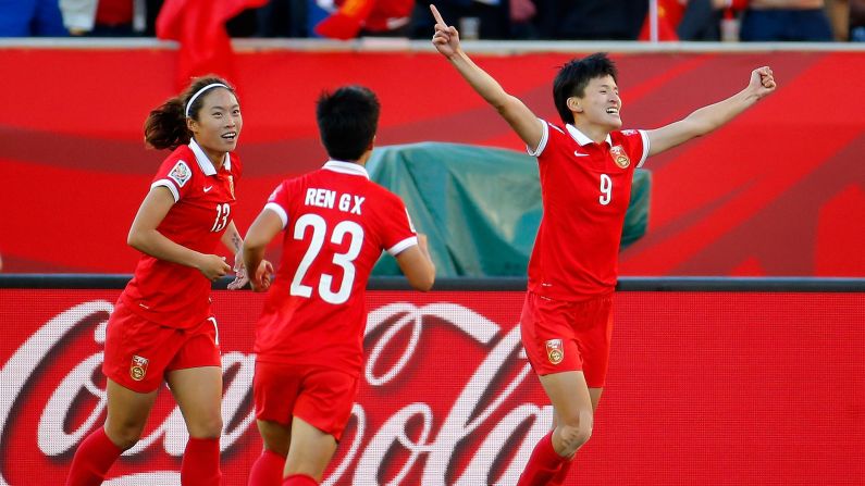 Wang, right, celebrates after scoring China's second goal.