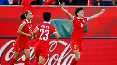 Wang, right, celebrates after scoring China's second goal.