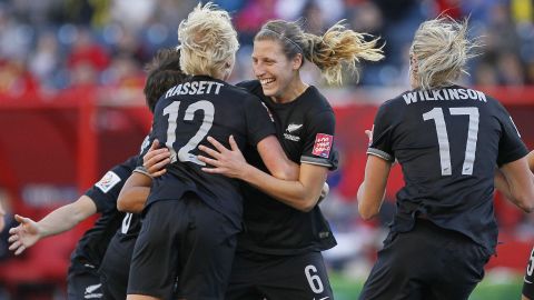 New Zealand's Rebekah Stott, center, and Betsy Hassett celebrate Stott's goal.