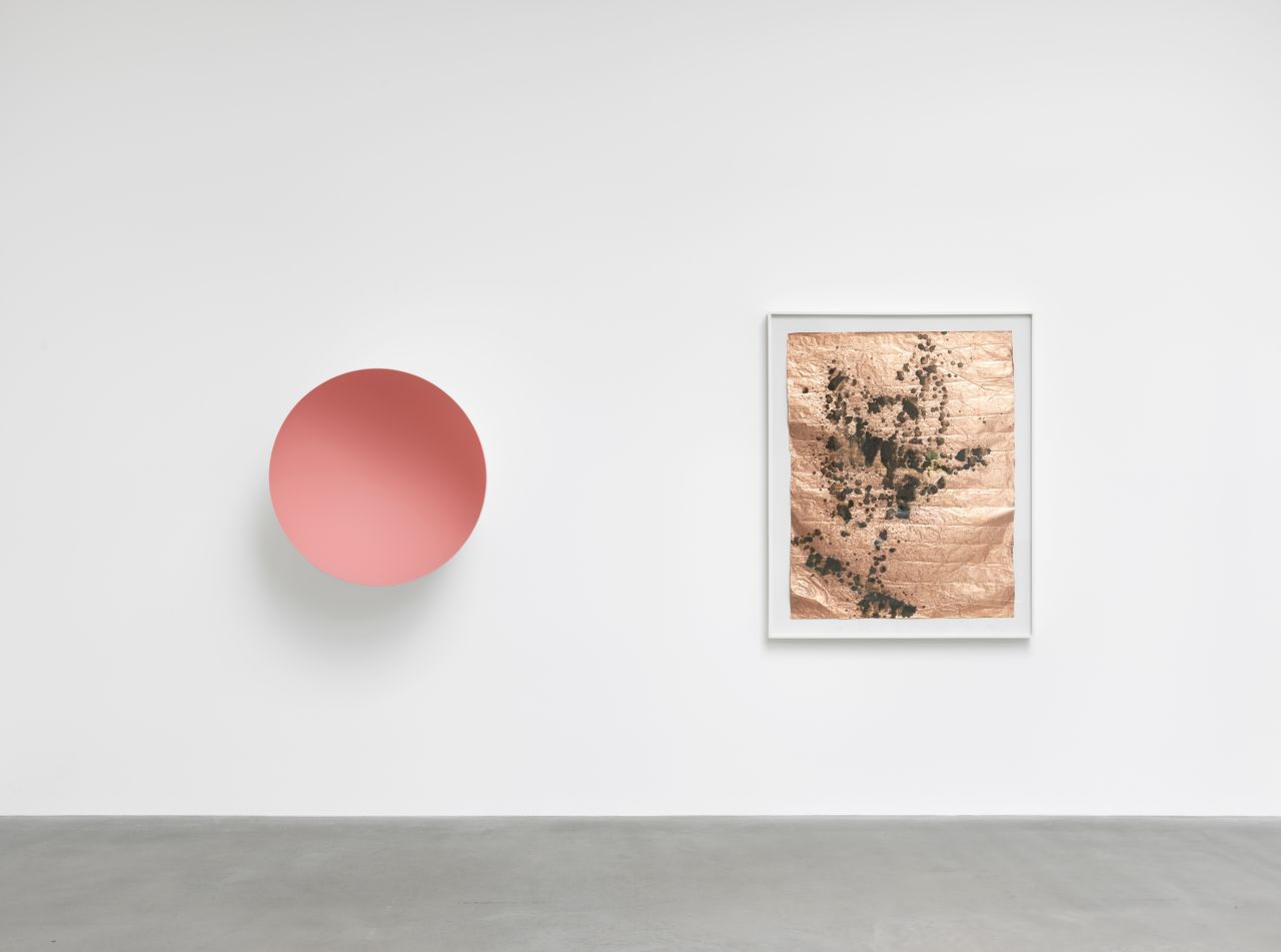 Anish Kapoor produced this piece on fiber glass (left) especially for the exhibition. It sits alongside Andy Warhol's urinated 'spray' onto acidic paint on a sheet of metal.