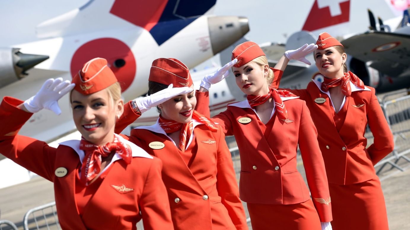 The Airshow is also a chance for airlines to display some of their planes, facilities and staff. Here the cabin crew of the Russian airline Aeroflot salute as they walk through the airshow on its second day.