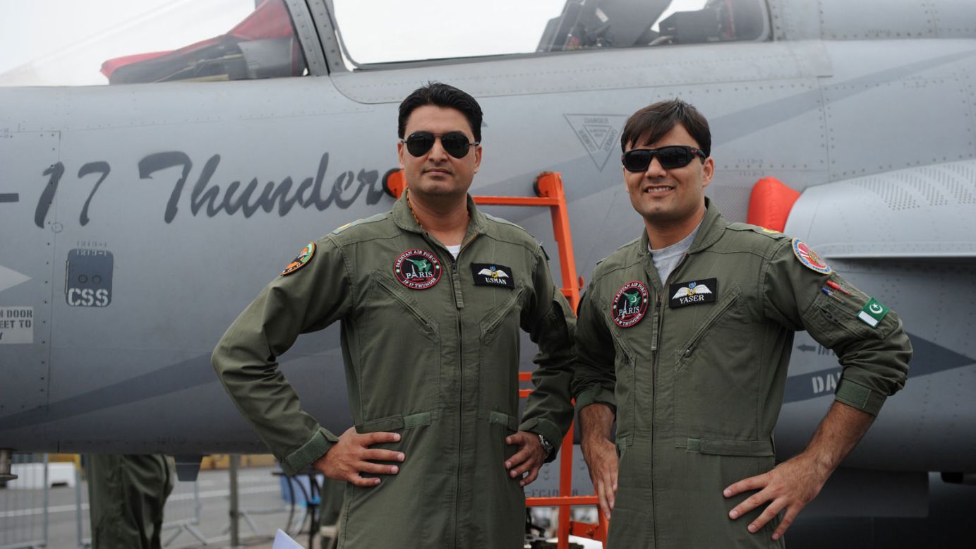 Pakistan Air Force Wing Commander Usman Ali, left, and Squadron Leader Yaser Mudasser, right, pose in front of a JF 17 Thunder. The fighter jet is a joint project between plane-makers in Pakistan and China.