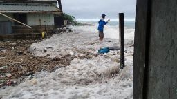 This photo taken on March 3, 2014 shows a resident surrounded by the on-rushing high tide energized by a storm surge that damaged a number of homes across Majuro.   It was the third inundation of the Marshall's capital atoll in the past 12 months. The Marshall Islands has put climate change at the top of its political and diplomatic agenda and officials saw the recently held Cartagena Dialogue as an opportunity to gather momentum.      AFP PHOTO / Karl Fellenius        (Photo credit should read Karl Fellenius/AFP/Getty Images)