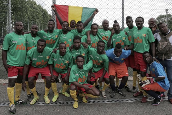 Malian players pose before the match against Guinea as part of the 'Balon Mundial' football tournament for migrants and foreigners.