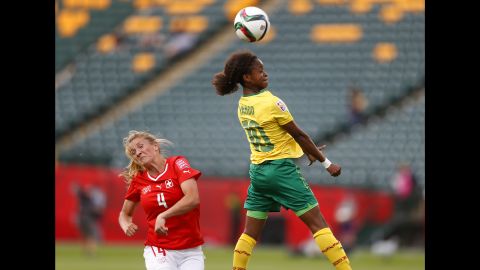 Rinast reacts as Jeannette Yango of Cameroon heads the ball. 