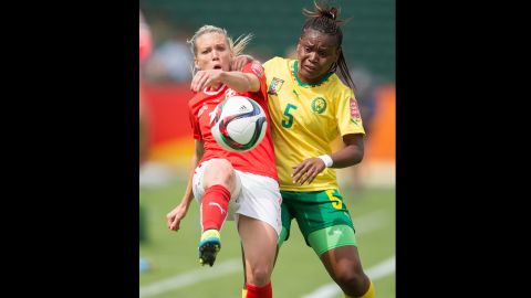 Switzerland's Lara Dickenmann and Cameroon's Augustine Ejangue jostle for the ball. 