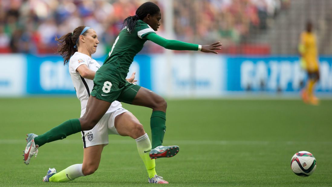 Nigeria's Asisat Oshoala leaps past Lauren Holiday as she chases the ball. 