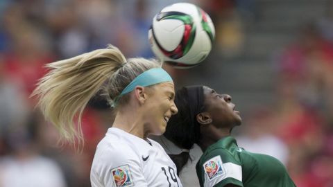 American defender Julie Johnston, left, and Nigeria's Courtney Dike compete for the ball. 