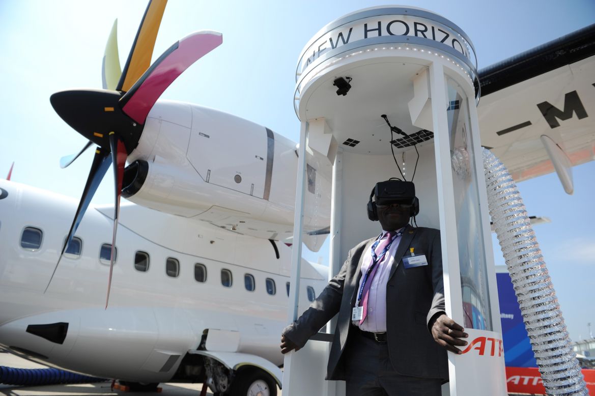 A visitor enjoys a 4D trip experience on the ATR stand at the International Paris Airshow at Le Bourget on June 17, 2015. 
