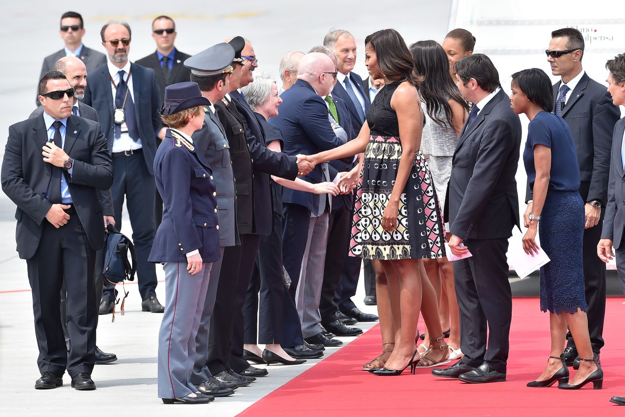 The Obamas shake hands at Milan's Malpensa Airport on June 17.