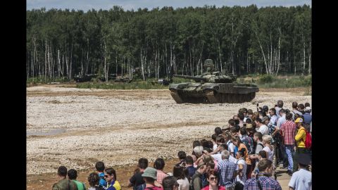  Dozens watch a Russian tank demonstration.