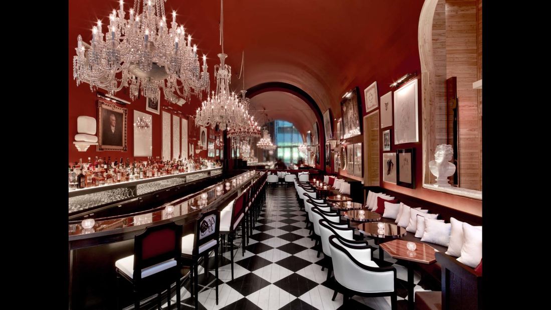 The Bar at Baccarat displays a range of works salon-style on its rich red walls. 