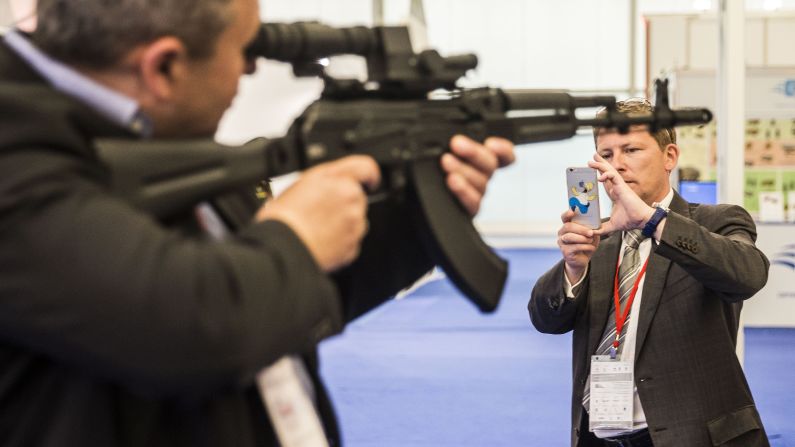  A man poses with a military rifle. 