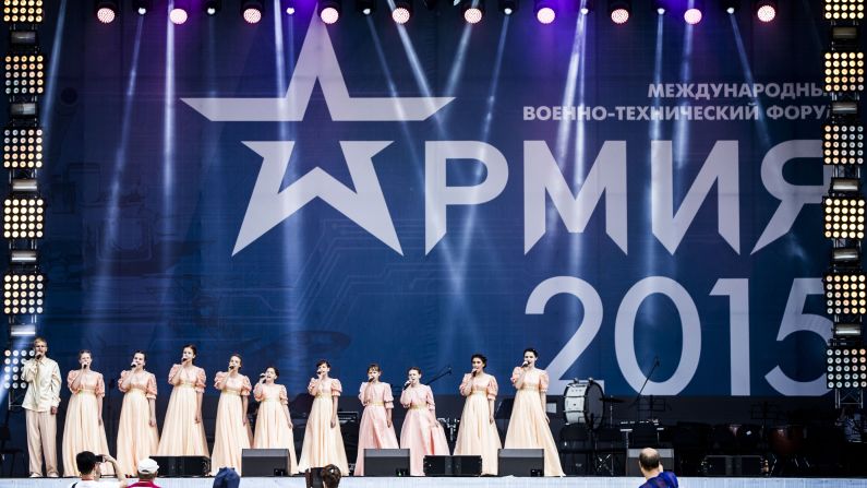 Performers sing a Russian patriotic song on stage. 