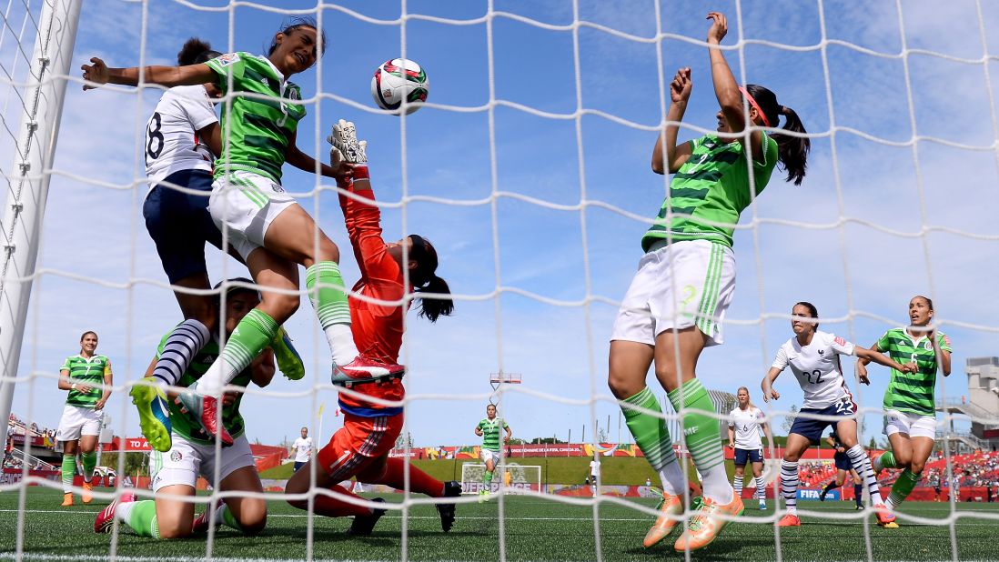 France's Marie Laure Delie, far left in white, heads her team's first goal against Mexico on June 17. France won 5-0 in Ottawa.