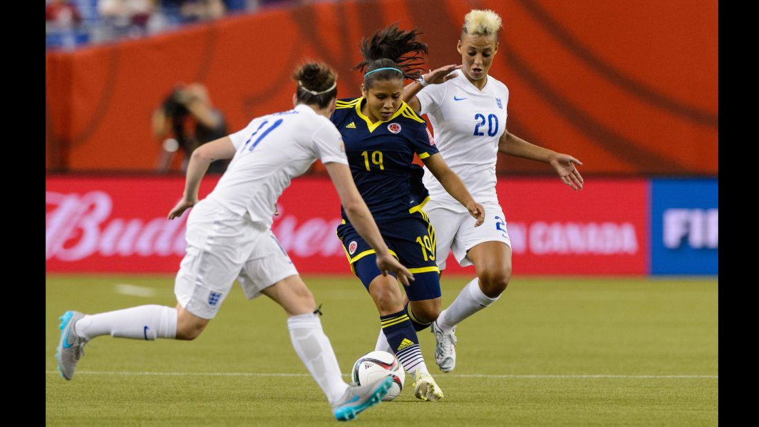 Leicy Santos of Colombia tries to move the ball past England defenders.