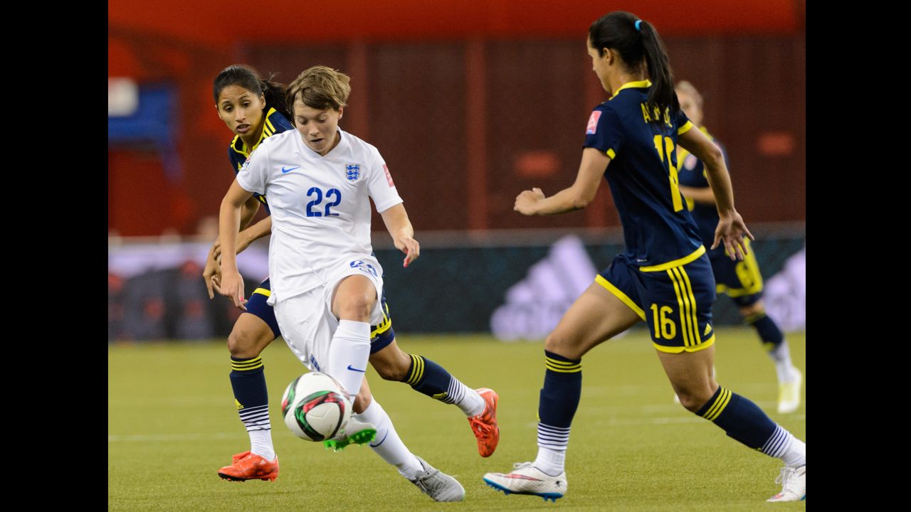 Fran Kirby of England tries to move the ball past Lady Andrade, right, of Colombia. 