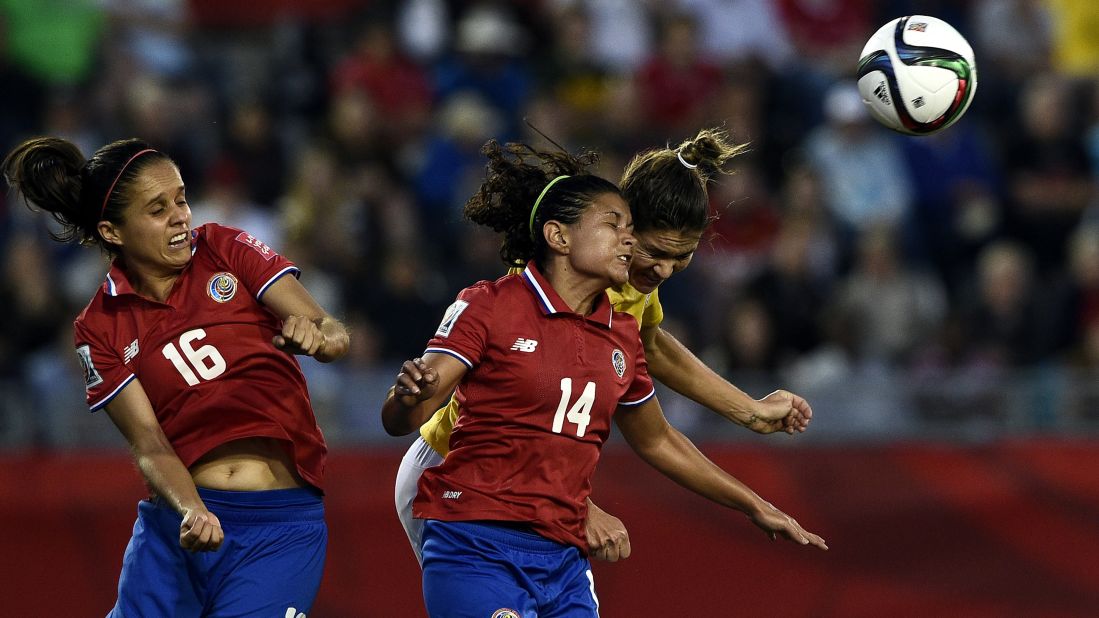 Costa Rican midfielder Katherine Alvarado, left, and forward Maria Barrantes jump for the ball. 