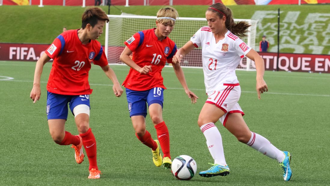Hyeri Kim, left, and Yumi Kang of South Korea defend Alexia Putellas of Spain.