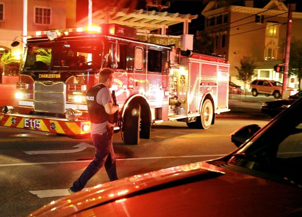 An armed police officer moves up Calhoun Street on June 17.