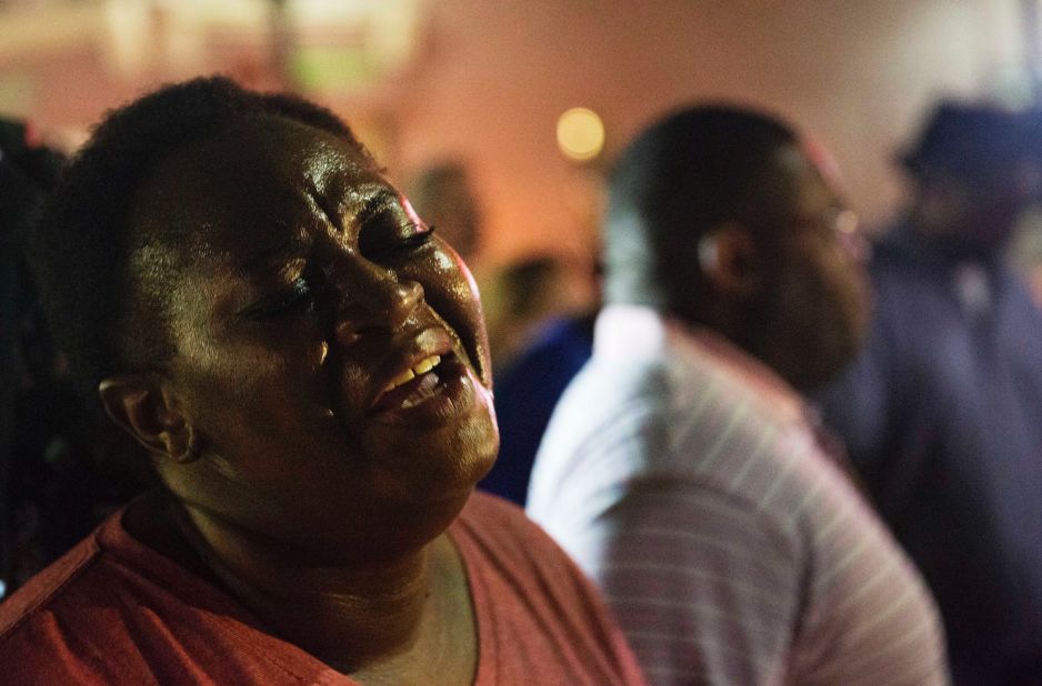 A woman joins a prayer circle on June 17.