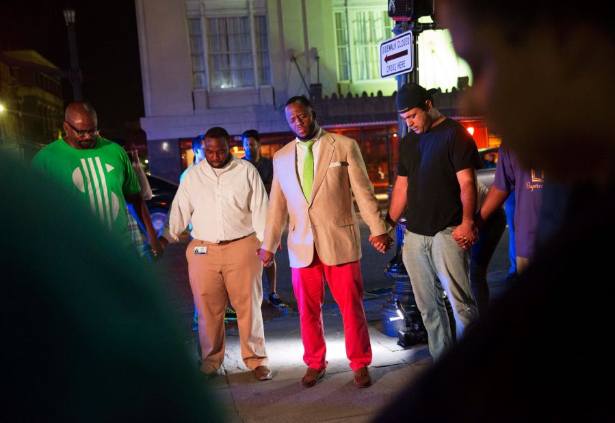 People in Charleston pray following the shooting on June 17.