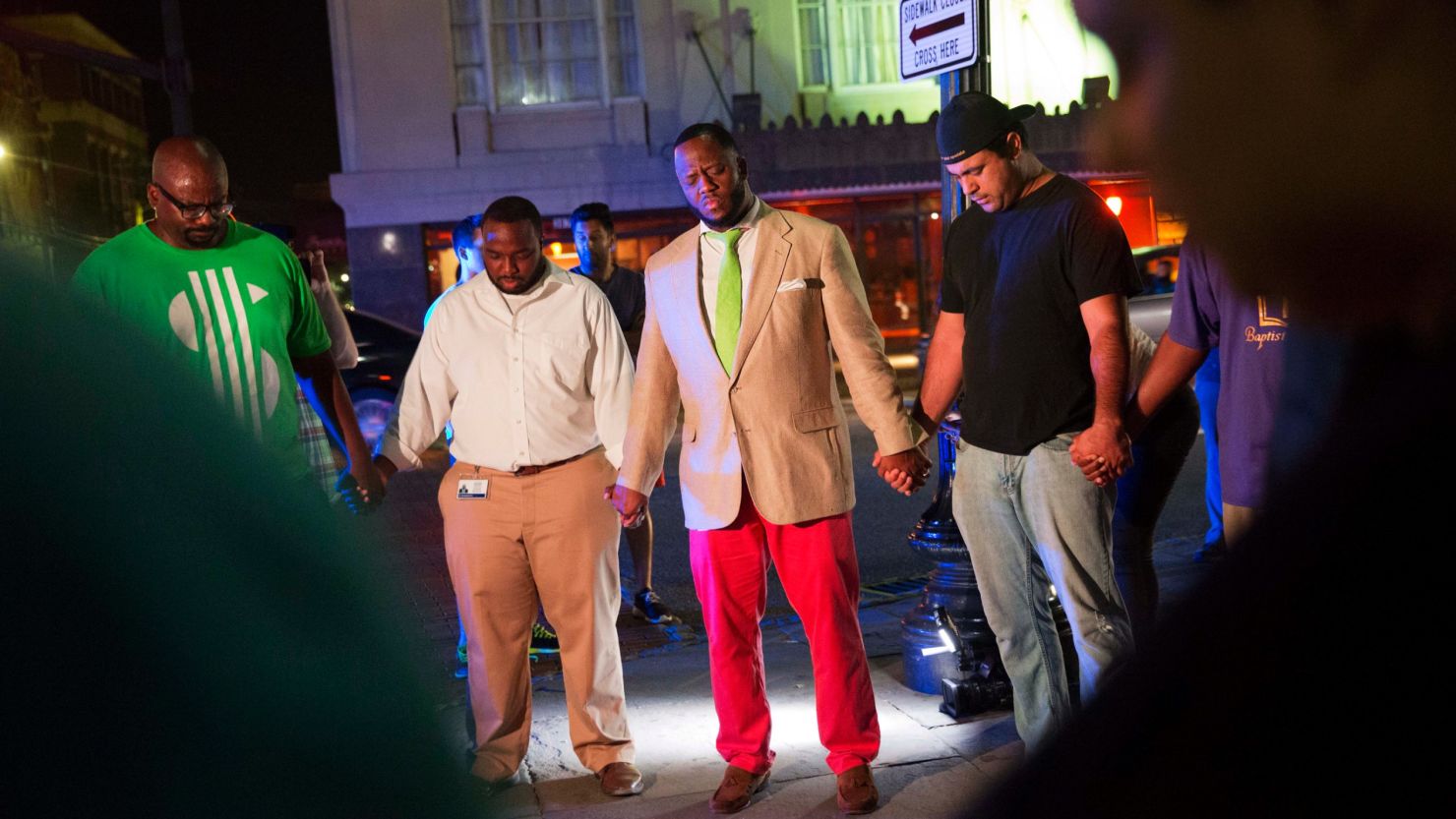 Worshippers pray following the shooting.